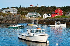 Monhegan Island Harbor with Lighthouse on Hilltop in Maine
